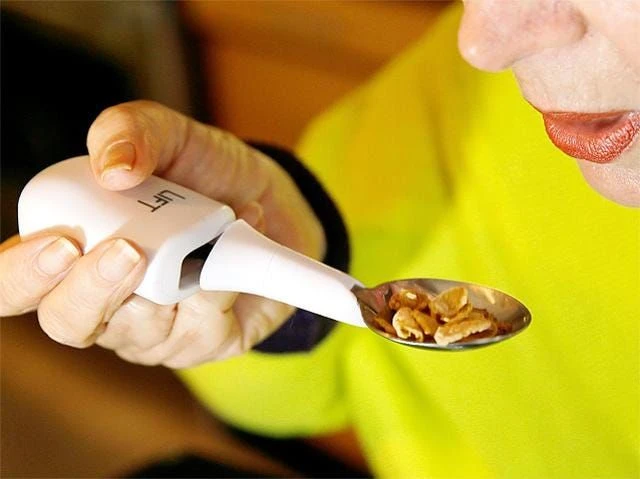 Elderly person eating with a stabilising smart spoon